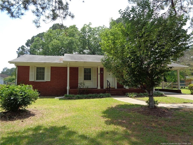 711 Fairview St, Fayetteville, NC 28312 - view of front of home with covered porch, brick siding, and a front lawn