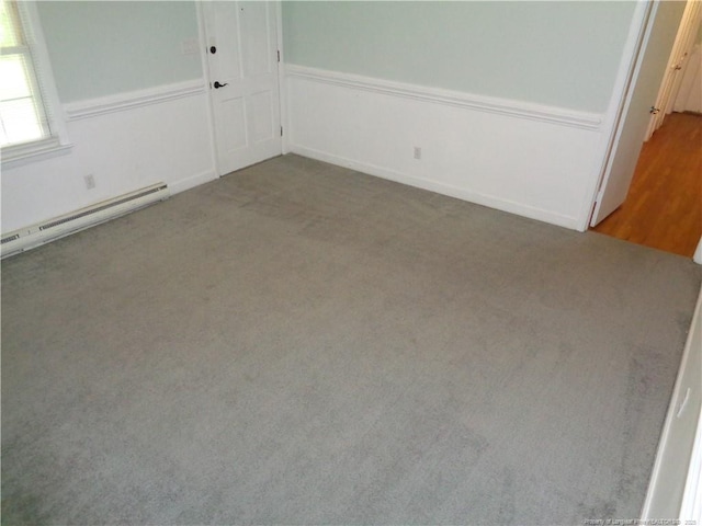 711 Fairview St, Fayetteville, NC 28312 - spare room with a baseboard heating unit, carpet flooring, and wainscoting
