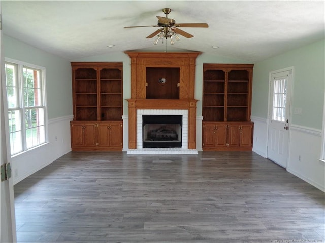 711 Fairview St, Fayetteville, NC 28312 - unfurnished living room featuring a fireplace, a ceiling fan, vaulted ceiling, wood finished floors, and wainscoting