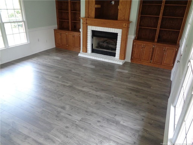 711 Fairview St, Fayetteville, NC 28312 - unfurnished living room featuring a brick fireplace, dark wood finished floors, and baseboards