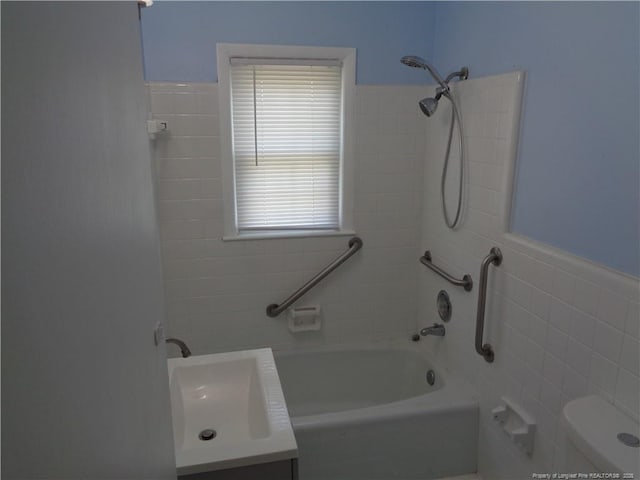 711 Fairview St, Fayetteville, NC 28312 - full bathroom featuring vanity, shower / tub combination, toilet, and tile walls