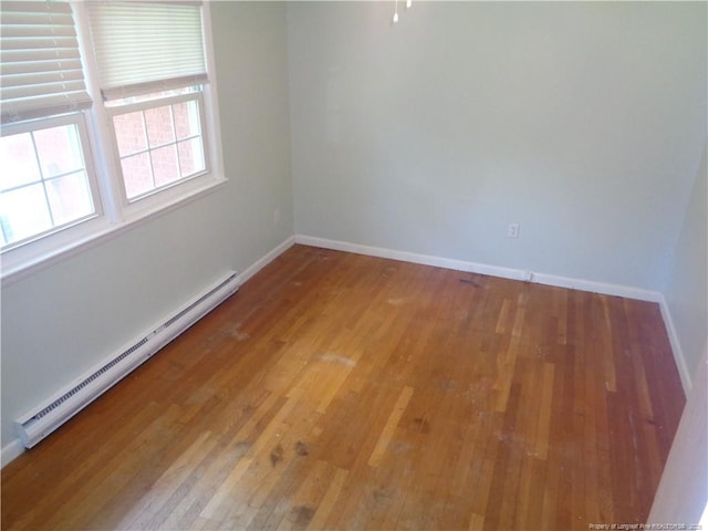 711 Fairview St, Fayetteville, NC 28312 - empty room featuring a baseboard heating unit, light wood-style flooring, and baseboards