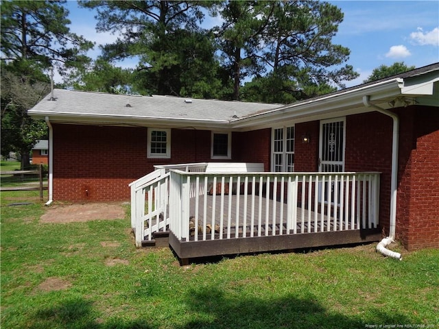 711 Fairview St, Fayetteville, NC 28312 - back of property with brick siding, a yard, and a wooden deck