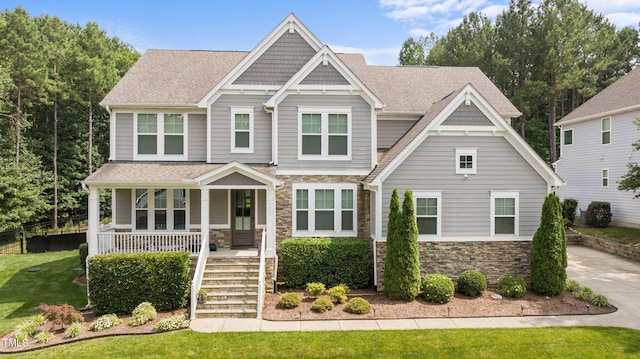 7410 Chouder Ln, Wake Forest, NC 27587 - craftsman inspired home with stone siding, a porch, and roof with shingles