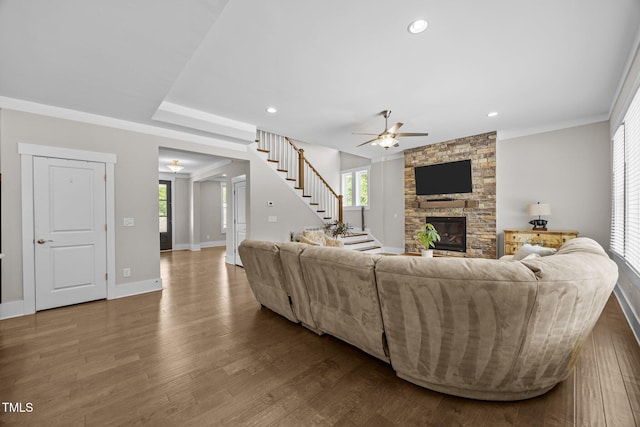 7410 Chouder Ln, Wake Forest, NC 27587 - living room featuring a ceiling fan, a fireplace, dark wood-type flooring, stairway, and recessed lighting