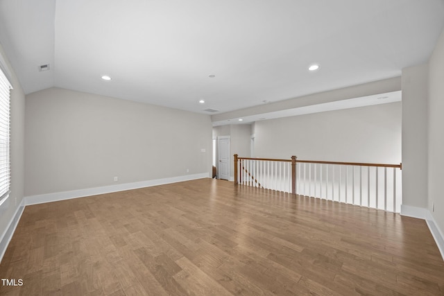 7410 Chouder Ln, Wake Forest, NC 27587 - empty room featuring wood finished floors, recessed lighting, and vaulted ceiling