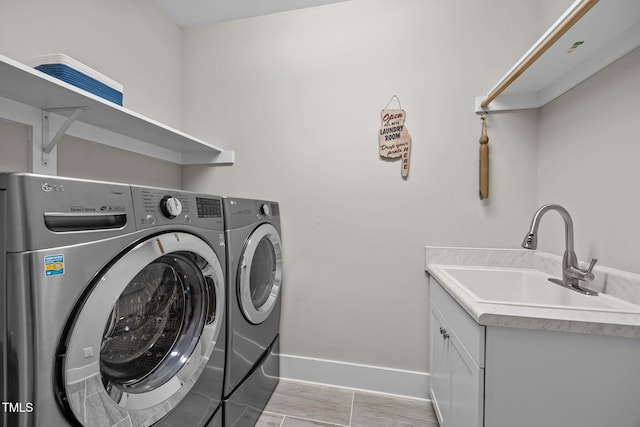 7410 Chouder Ln, Wake Forest, NC 27587 - washroom with washer and dryer, cabinet space, and light wood finished floors