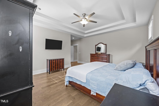 7410 Chouder Ln, Wake Forest, NC 27587 - bedroom featuring a raised ceiling, wood finished floors, and ceiling fan