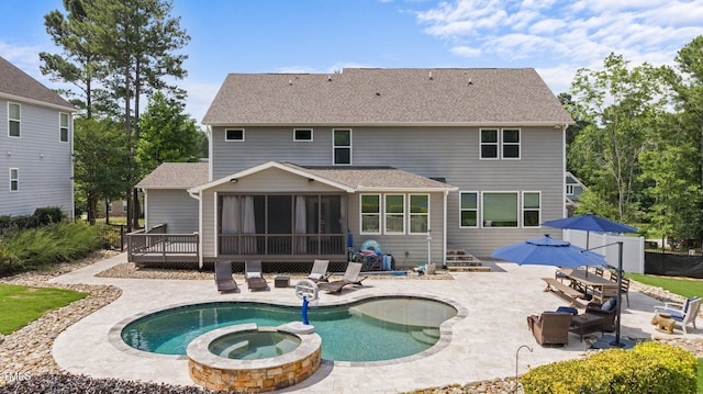 7410 Chouder Ln, Wake Forest, NC 27587 - back of house featuring a sunroom, a patio, a shingled roof, and a pool with connected hot tub