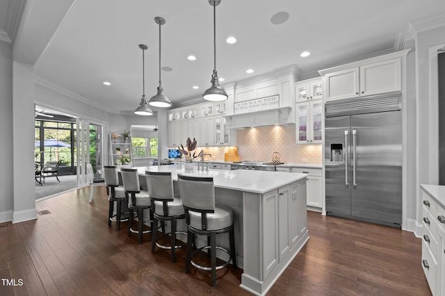 2112 Colin Hill Ct, Wake Forest, NC 27587 - kitchen featuring built in fridge, ornamental molding, light countertops, a center island with sink, and tasteful backsplash
