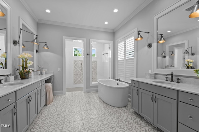 2112 Colin Hill Ct, Wake Forest, NC 27587 - full bath with two vanities, a freestanding tub, a walk in shower, recessed lighting, and crown molding