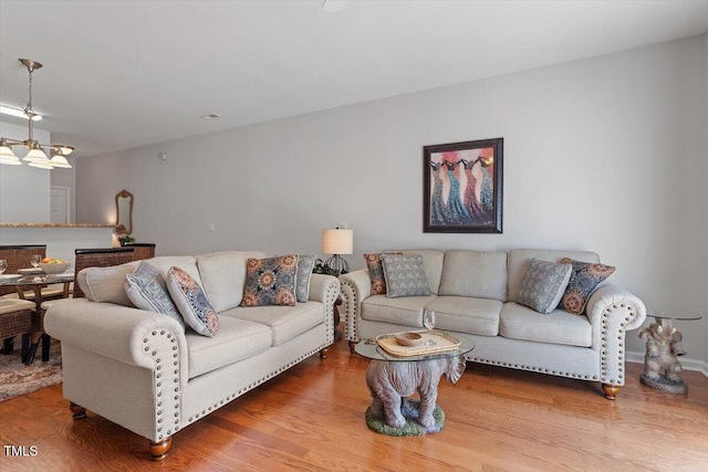1109 Hadel Pl, Knightdale, NC 27545 - living room with a chandelier and wood finished floors