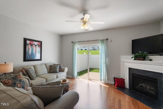 1109 Hadel Pl, Knightdale, NC 27545 - living area featuring wood finished floors, ceiling fan, and a fireplace with flush hearth