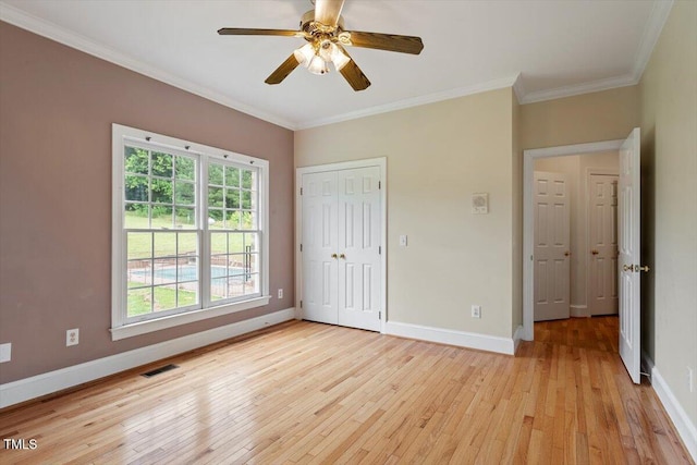 8415 Meadow View Ln, Bahama, NC 27503 - unfurnished bedroom featuring light wood-type flooring, ornamental molding, a closet, and ceiling fan