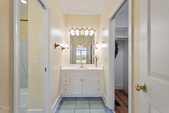 8415 Meadow View Ln, Bahama, NC 27503 - bathroom featuring vanity, crown molding, and a walk in closet