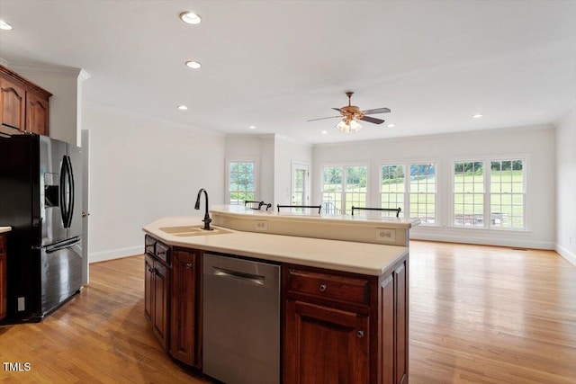8415 Meadow View Ln, Bahama, NC 27503 - kitchen with dishwasher, black refrigerator with ice dispenser, light wood-style flooring, ceiling fan, and light countertops