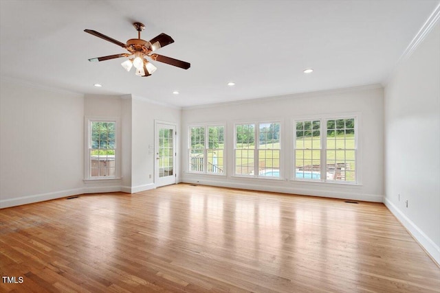 8415 Meadow View Ln, Bahama, NC 27503 - unfurnished living room featuring plenty of natural light, light wood finished floors, crown molding, a ceiling fan, and recessed lighting