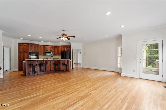 8415 Meadow View Ln, Bahama, NC 27503 - unfurnished living room featuring ornamental molding, light wood-style flooring, recessed lighting, and a ceiling fan