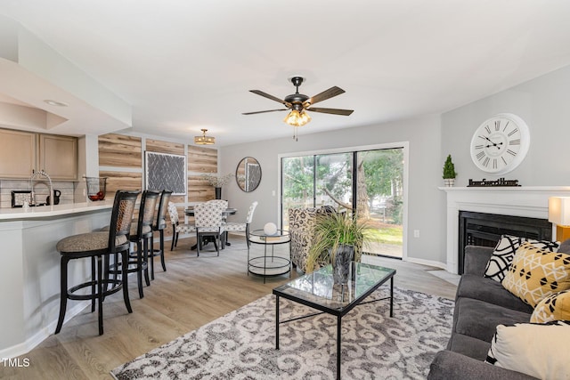 7708 Falcon Rest Cir, Raleigh, NC 27615 - living room featuring a ceiling fan, a fireplace with flush hearth, and light wood finished floors