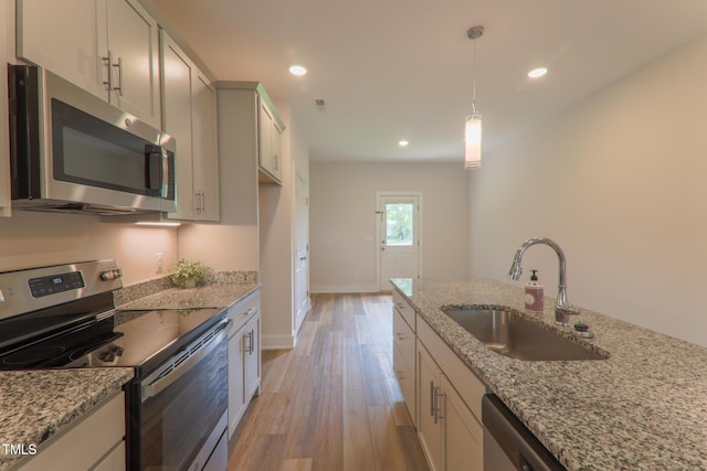 202 E S St, Fremont, NC 27830 - kitchen featuring stainless steel appliances, light wood-style flooring, light stone counters, and recessed lighting