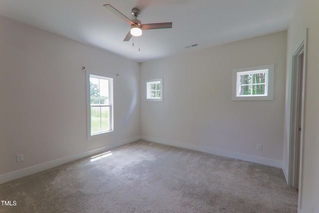 202 E S St, Fremont, NC 27830 - spare room featuring light colored carpet and a ceiling fan
