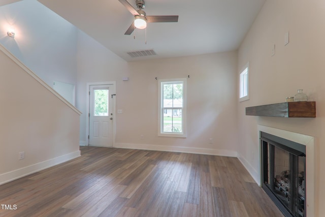 202 E S St, Fremont, NC 27830 - unfurnished living room featuring wood finished floors, healthy amount of natural light, a fireplace, and a ceiling fan