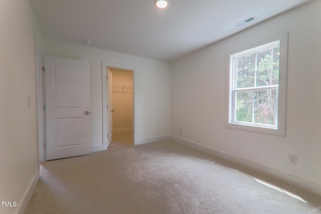 202 E S St, Fremont, NC 27830 - unfurnished bedroom featuring multiple windows, light carpet, and a spacious closet
