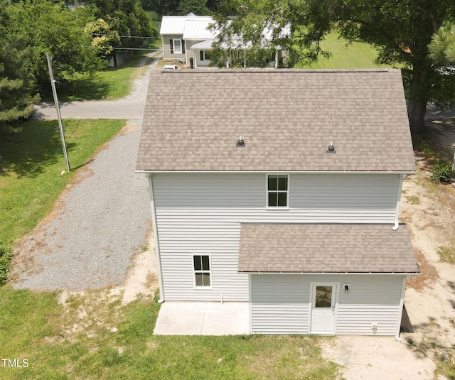 202 E S St, Fremont, NC 27830 - back of property with roof with shingles, a lawn, and a patio area