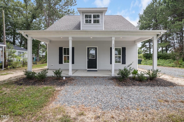 202 E S St, Fremont, NC 27830 - view of front facade featuring a porch, a shingled roof, and gravel driveway