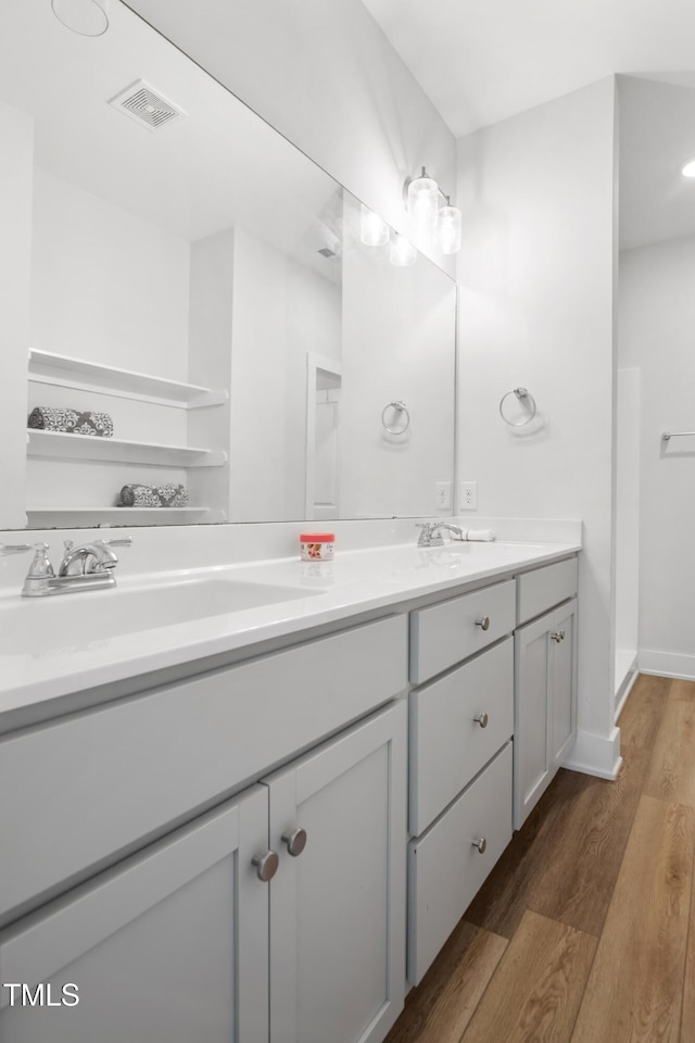 202 E S St, Fremont, NC 27830 - bathroom featuring double vanity and wood finished floors