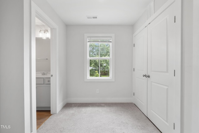 202 E S St, Fremont, NC 27830 - unfurnished bedroom with ensuite bathroom, carpet flooring, and a closet