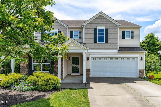 2011 Unbridled Dr, Knightdale, NC 27545 - view of front of home with driveway, stone siding, an attached garage, and a shingled roof