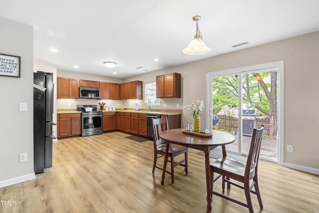 2011 Unbridled Dr, Knightdale, NC 27545 - kitchen featuring appliances with stainless steel finishes, light wood finished floors, baseboards, and recessed lighting