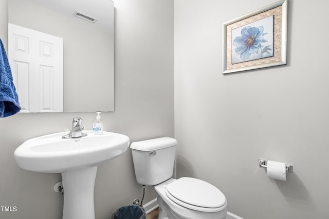 2011 Unbridled Dr, Knightdale, NC 27545 - half bathroom with baseboards, toilet, and a sink