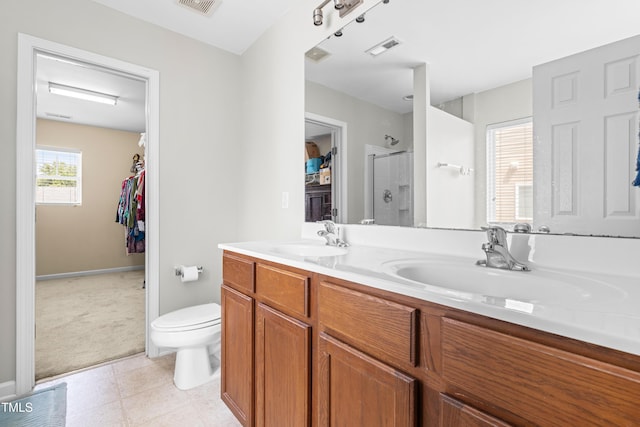 2011 Unbridled Dr, Knightdale, NC 27545 - full bath featuring an enclosed shower, double vanity, toilet, baseboards, and a spacious closet