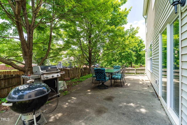2011 Unbridled Dr, Knightdale, NC 27545 - fenced backyard with a patio area, outdoor dining area, and grilling area