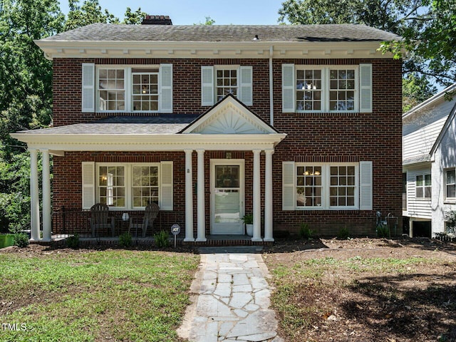 907 W Johnson St, Raleigh, NC 27605 - view of front facade featuring a porch, brick siding, and a chimney