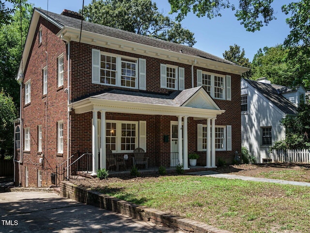 907 W Johnson St, Raleigh, NC 27605 - view of front of home featuring a porch, brick siding, a front yard, and roof with shingles
