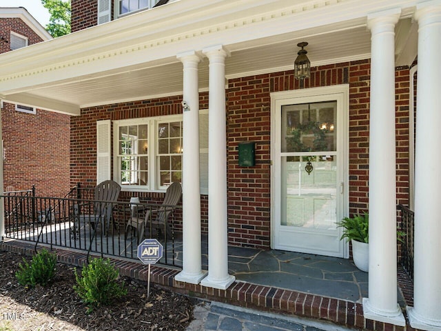 907 W Johnson St, Raleigh, NC 27605 - entrance to property featuring covered porch and brick siding