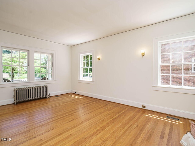 907 W Johnson St, Raleigh, NC 27605 - unfurnished room featuring radiator and light wood-style flooring