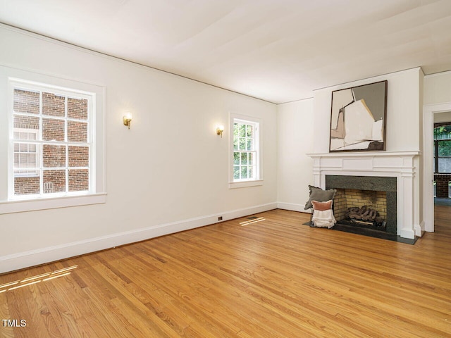 907 W Johnson St, Raleigh, NC 27605 - unfurnished living room featuring light wood finished floors and a fireplace with flush hearth