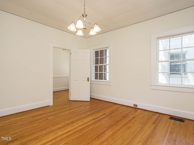 907 W Johnson St, Raleigh, NC 27605 - spare room featuring a chandelier and light wood finished floors