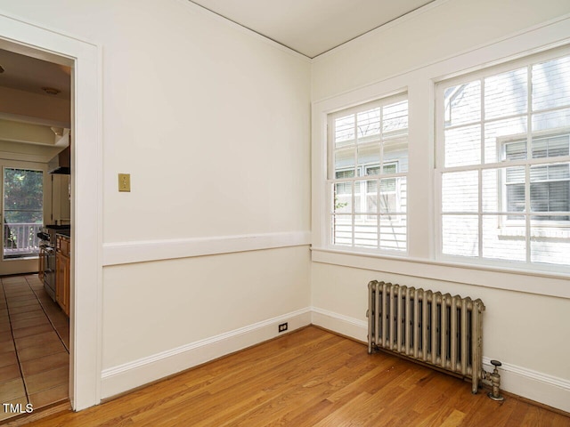 907 W Johnson St, Raleigh, NC 27605 - spare room featuring radiator heating unit and light wood-style floors