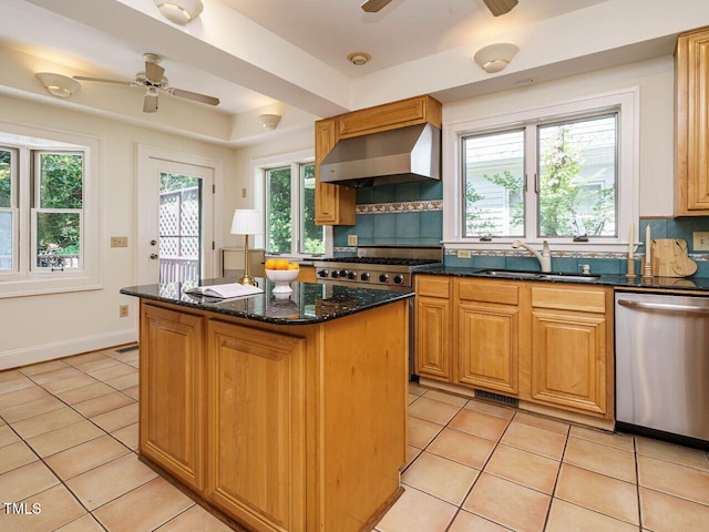 907 W Johnson St, Raleigh, NC 27605 - kitchen featuring stainless steel appliances, wall chimney range hood, a ceiling fan, and light tile patterned flooring