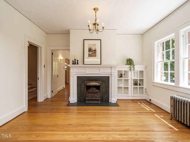 907 W Johnson St, Raleigh, NC 27605 - living area featuring radiator, ornamental molding, a chandelier, light wood-style floors, and stairs