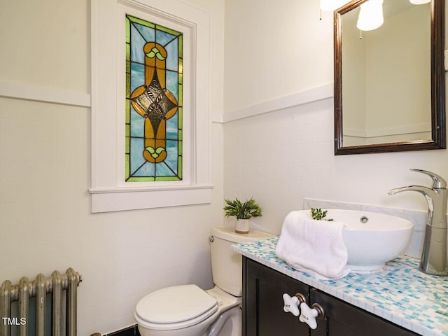 907 W Johnson St, Raleigh, NC 27605 - bathroom featuring tile walls, radiator, and vanity