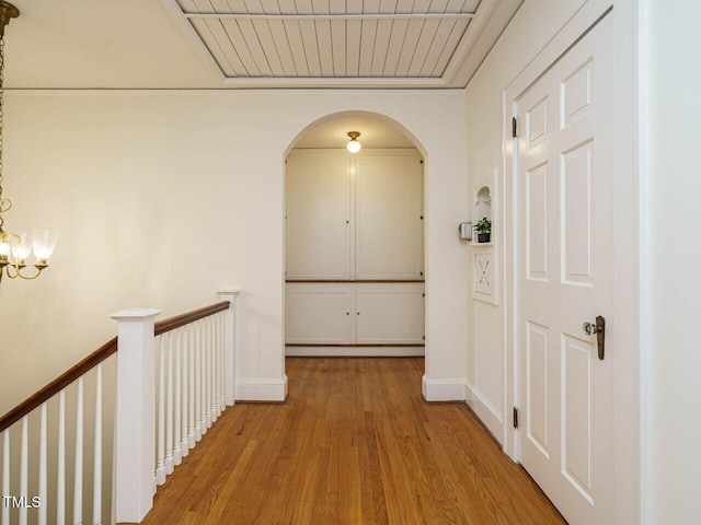907 W Johnson St, Raleigh, NC 27605 - hall with wood finished floors, arched walkways, and an upstairs landing