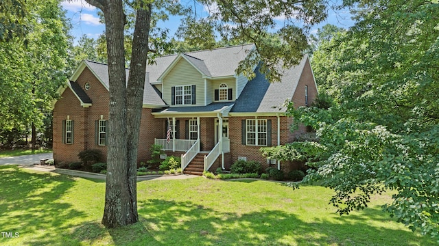102 Sevendales Dr, Goldsboro, NC 27534 - traditional-style home with a front lawn, brick siding, and covered porch