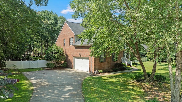 102 Sevendales Dr, Goldsboro, NC 27534 - view of home's exterior with brick siding, concrete driveway, an attached garage, and roof with shingles