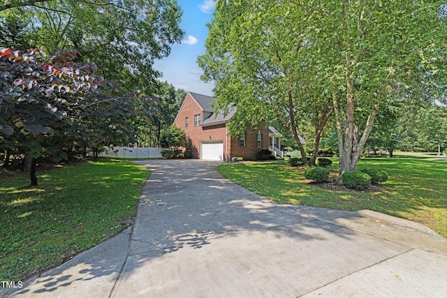102 Sevendales Dr, Goldsboro, NC 27534 - view of property hidden behind natural elements featuring driveway, brick siding, and a garage